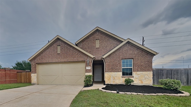 ranch-style home featuring an attached garage, brick siding, and fence