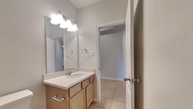 bathroom featuring tile patterned flooring, toilet, and vanity