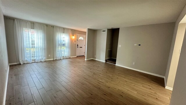 407 Bendwood Dr Unit 38, Houston, TX 77024 - spare room featuring baseboards, visible vents, and dark wood finished floors