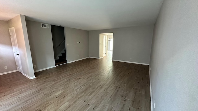 407 Bendwood Dr Unit 38, Houston, TX 77024 - spare room featuring stairway, baseboards, visible vents, and wood finished floors