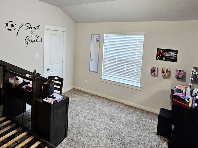 carpeted office featuring baseboards and vaulted ceiling