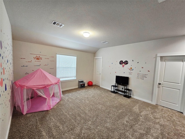playroom with a textured ceiling, carpet floors, baseboards, and visible vents