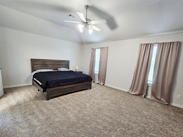 carpeted bedroom with baseboards, vaulted ceiling, and ceiling fan