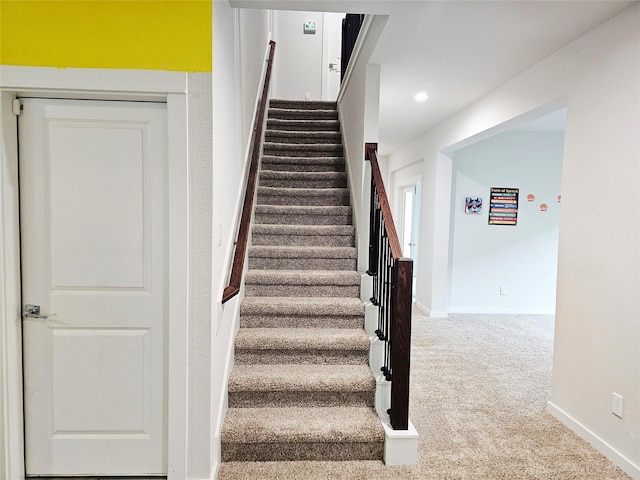 staircase with carpet flooring, baseboards, and recessed lighting