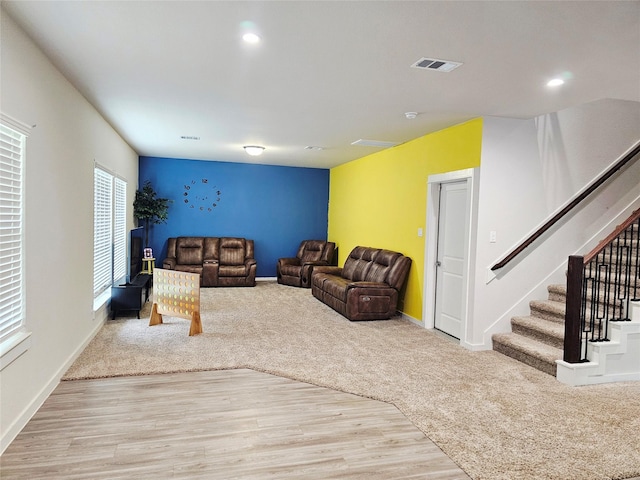 living room with stairs, wood finished floors, baseboards, and recessed lighting