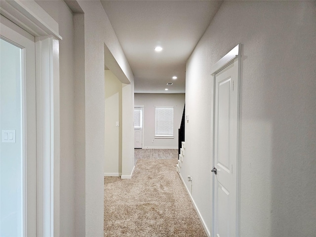 hall with recessed lighting, baseboards, and carpet floors