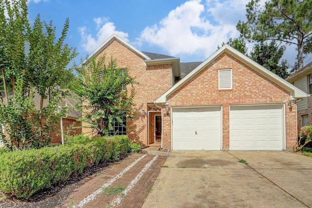 traditional-style house with concrete driveway, brick siding, and a garage