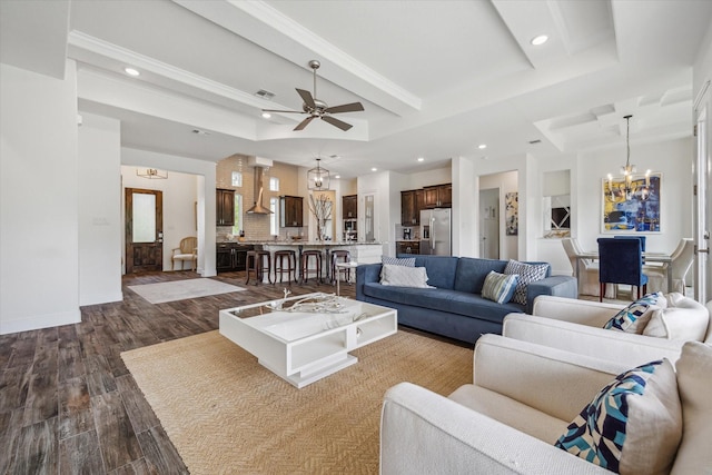 3419 Campestres, Spring Branch, TX 78070 - living room with ceiling fan with notable chandelier, visible vents, recessed lighting, dark wood-style floors, and a raised ceiling