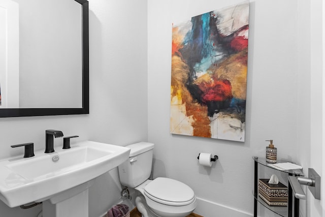 203 S Empress Green Pl, Montgomery, TX 77316 - bathroom featuring toilet, baseboards, and a sink