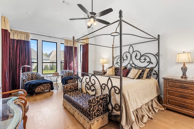 203 S Empress Green Pl, Montgomery, TX 77316 - bedroom featuring a ceiling fan, vaulted ceiling, wood finished floors, and visible vents