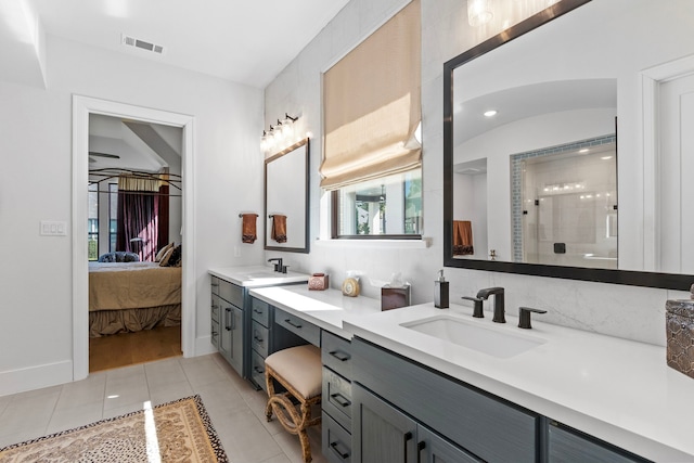 203 S Empress Green Pl, Montgomery, TX 77316 - ensuite bathroom with double vanity, a sink, tile patterned floors, visible vents, and a shower stall