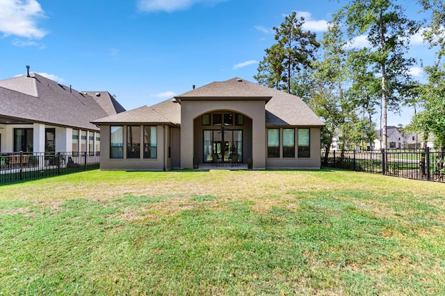 203 S Empress Green Pl, Montgomery, TX 77316 - back of house with a shingled roof, a yard, stucco siding, and a fenced backyard