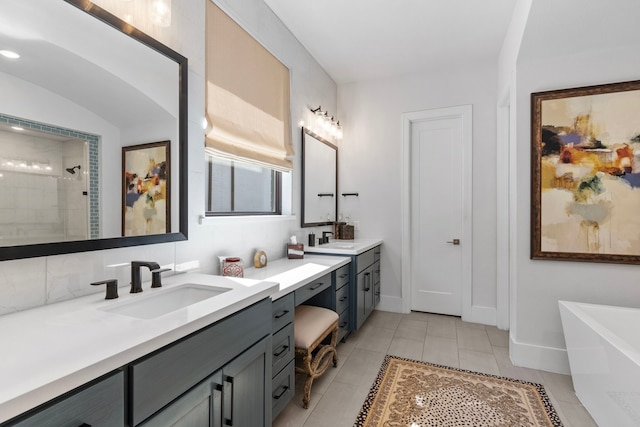 203 S Empress Green Pl, Montgomery, TX 77316 - full bathroom with a tile shower, a sink, two vanities, tile patterned flooring, and a freestanding tub