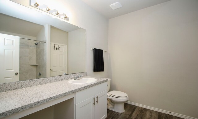 18715 Callalily Bloom Ct, Tomball, TX 77377 - bathroom featuring toilet, wood finished floors, baseboards, walk in shower, and vanity