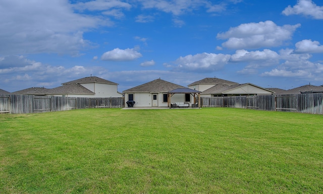 18715 Callalily Bloom Ct, Tomball, TX 77377 - rear view of house featuring a fenced backyard, a gazebo, a patio, and a lawn
