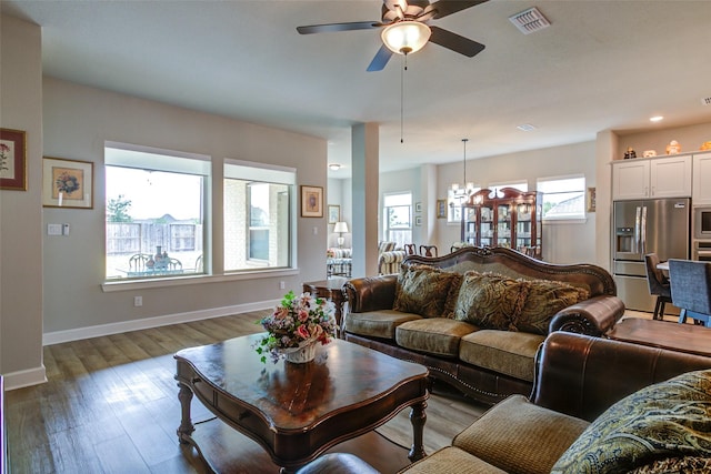 9823 Starry Night Ln, Manvel, TX 77578 - living room with recessed lighting, baseboards, visible vents, ceiling fan with notable chandelier, and wood finished floors