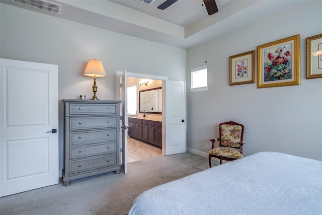 9823 Starry Night Ln, Manvel, TX 77578 - bedroom with ensuite bath, visible vents, light carpet, a tray ceiling, and baseboards
