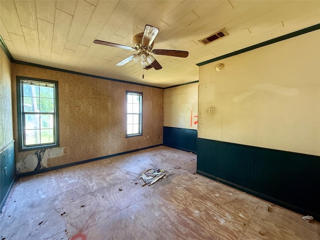 spare room with wooden ceiling, visible vents, a ceiling fan, and ornamental molding