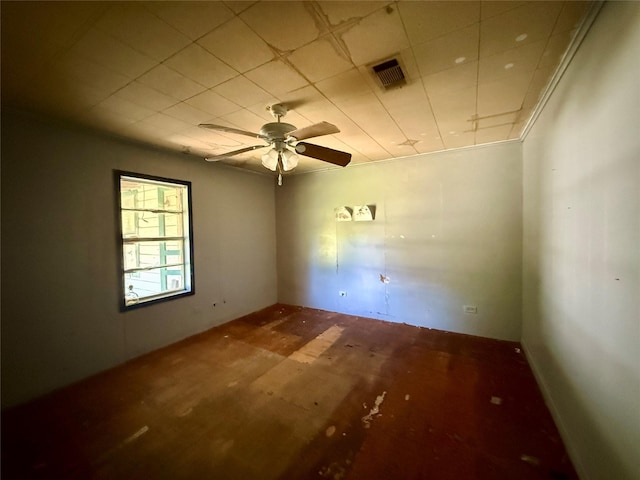 spare room featuring a ceiling fan and visible vents
