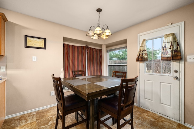 7210 Avocet Ln, Houston, TX 77040 - dining room with an inviting chandelier, baseboards, and stone finish flooring