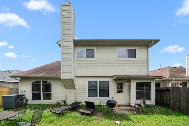7210 Avocet Ln, Houston, TX 77040 - rear view of property featuring fence, cooling unit, and a chimney