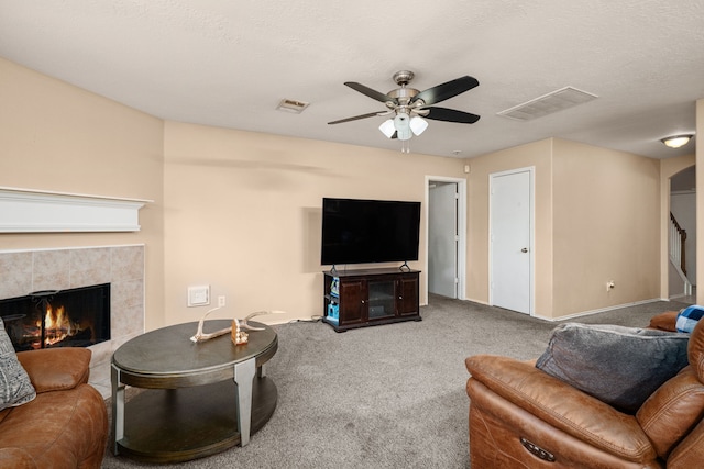 7210 Avocet Ln, Houston, TX 77040 - living area featuring carpet, a ceiling fan, visible vents, and a tile fireplace
