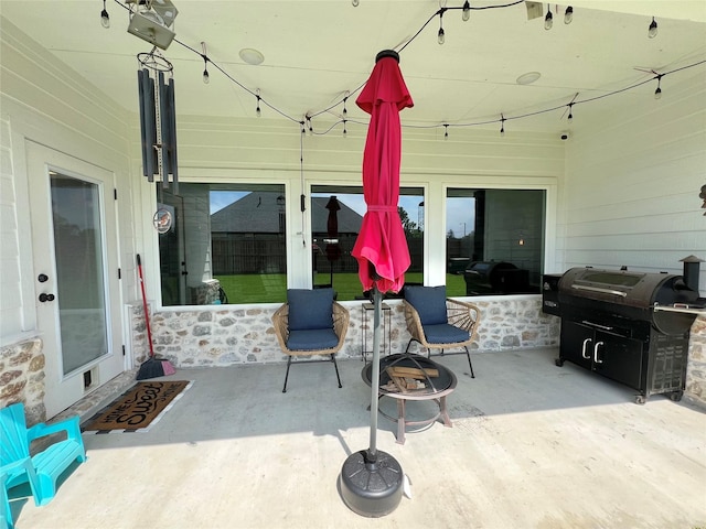 view of patio / terrace with an outdoor fire pit and area for grilling