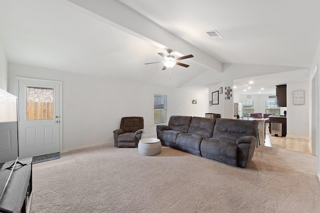 living area with light colored carpet, visible vents, ceiling fan, baseboards, and vaulted ceiling with beams