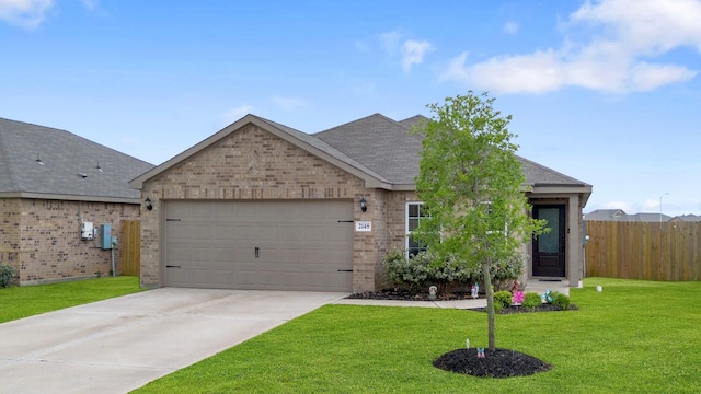 ranch-style home featuring a garage, fence, a front yard, brick siding, and driveway