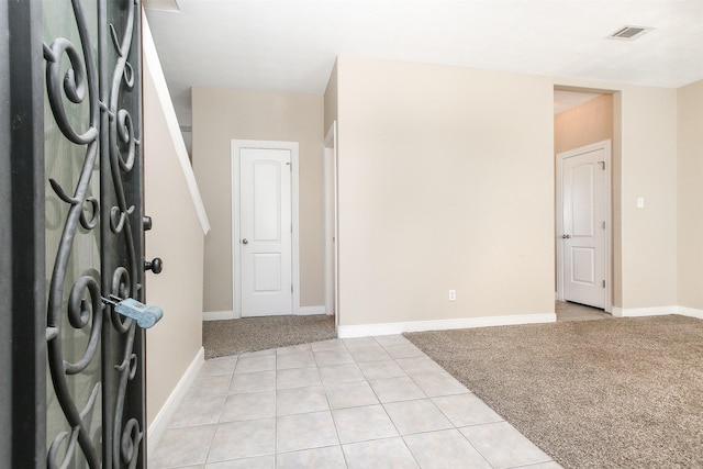 24006 Lestergate Dr, Spring, TX 77373 - foyer with light colored carpet, baseboards, light tile patterned floors, and visible vents