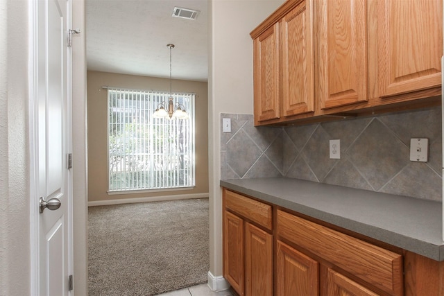 24006 Lestergate Dr, Spring, TX 77373 - kitchen with baseboards, visible vents, light carpet, decorative backsplash, and a notable chandelier
