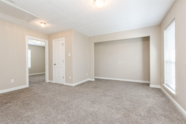 24006 Lestergate Dr, Spring, TX 77373 - carpeted empty room featuring attic access, baseboards, and a healthy amount of sunlight