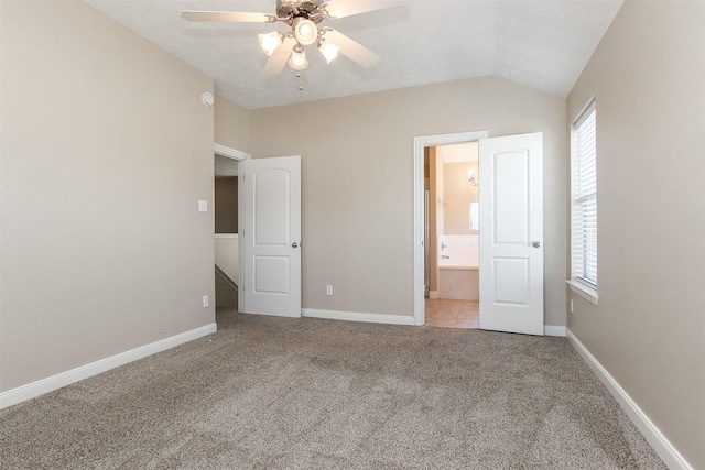 24006 Lestergate Dr, Spring, TX 77373 - unfurnished bedroom featuring carpet flooring, multiple windows, baseboards, and lofted ceiling