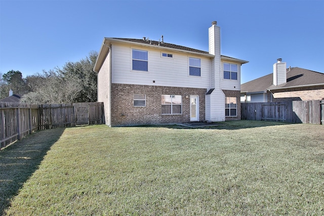 24006 Lestergate Dr, Spring, TX 77373 - back of property with a yard, brick siding, and a fenced backyard