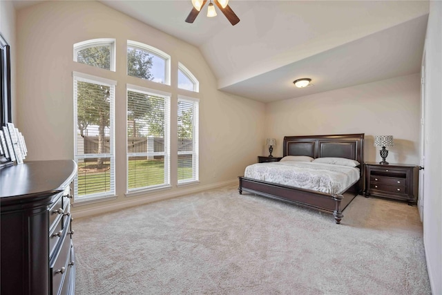 carpeted bedroom featuring vaulted ceiling, baseboards, and a ceiling fan
