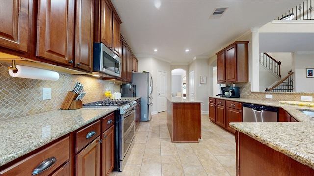 18818 Bene Vista Dr, Houston, TX 77084 - kitchen with light stone counters, visible vents, and appliances with stainless steel finishes