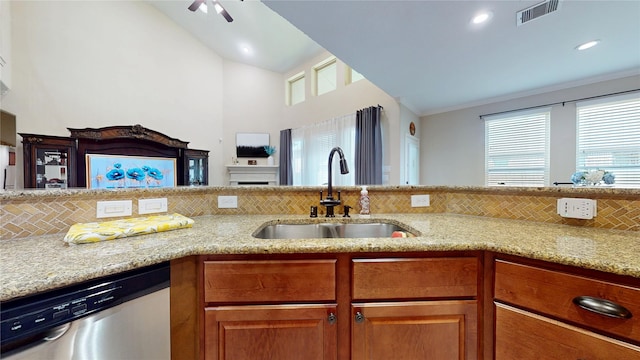 18818 Bene Vista Dr, Houston, TX 77084 - kitchen featuring a sink, tasteful backsplash, visible vents, stainless steel dishwasher, and light stone countertops