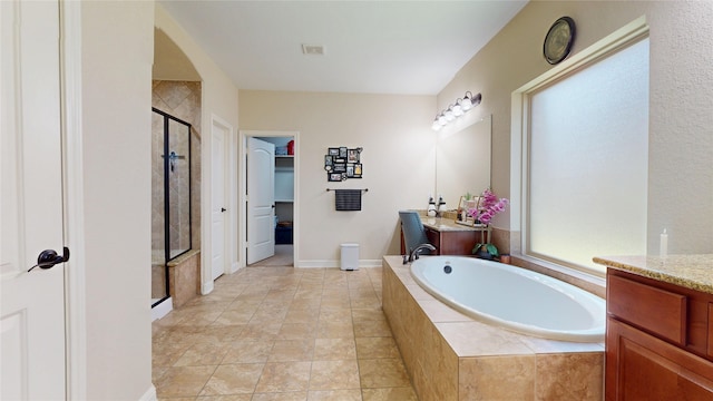 18818 Bene Vista Dr, Houston, TX 77084 - bathroom featuring a stall shower, vanity, a walk in closet, and a garden tub