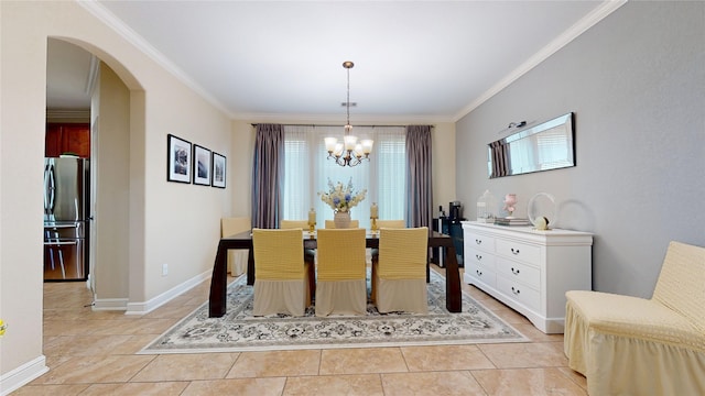18818 Bene Vista Dr, Houston, TX 77084 - dining area featuring crown molding, a notable chandelier, arched walkways, and baseboards