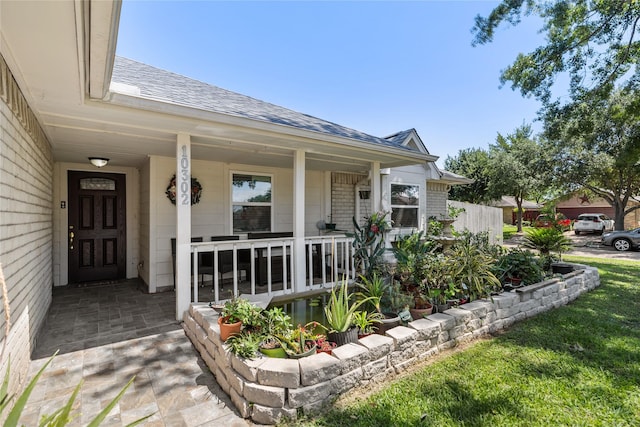 10302 Lybert Rd, Houston, TX 77041 - view of exterior entry with covered porch and a shingled roof
