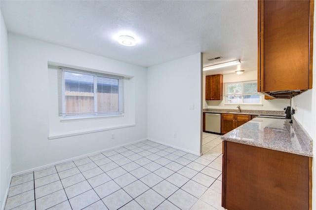 kitchen with a sink, light tile patterned flooring, visible vents, range, and stainless steel dishwasher