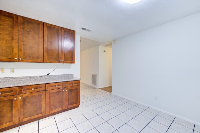 kitchen featuring baseboards and visible vents
