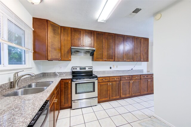 2215 Squire Dobbins Dr, Sugar Land, TX 77478 - kitchen featuring under cabinet range hood, light tile patterned flooring, visible vents, stainless steel electric range, and a sink