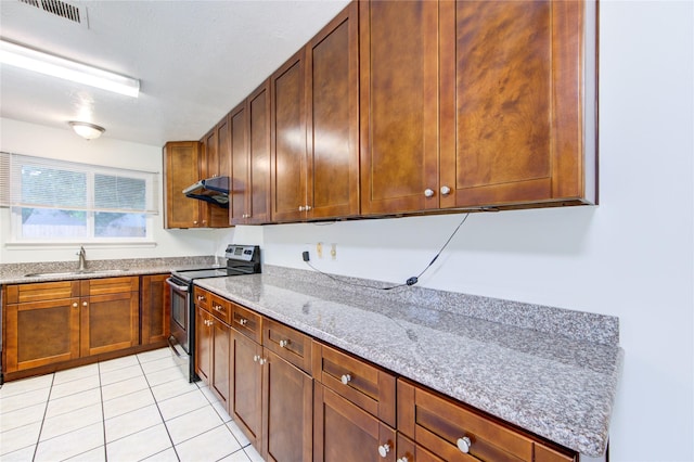 kitchen with light stone countertops, range hood, visible vents, stainless steel electric range, and a sink