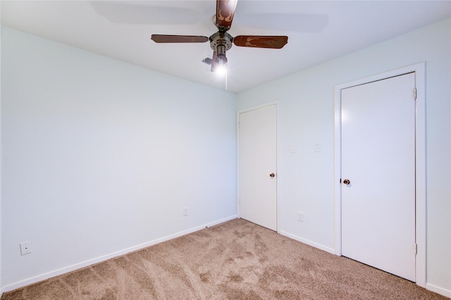 unfurnished bedroom featuring carpet flooring, baseboards, a ceiling fan, and visible vents