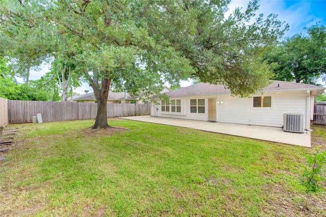 exterior space featuring central AC unit, a patio area, a fenced backyard, and a yard