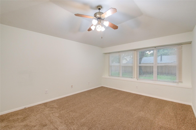 unfurnished room with vaulted ceiling, ceiling fan, carpet floors, and baseboards