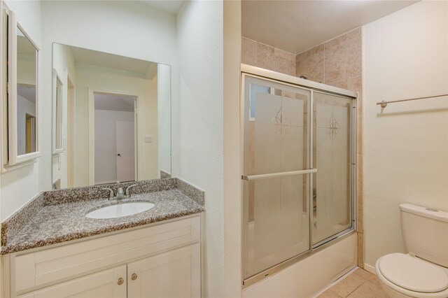 2215 Squire Dobbins Dr, Sugar Land, TX 77478 - full bathroom with toilet, tile patterned flooring, vanity, and combined bath / shower with glass door