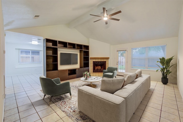 2215 Squire Dobbins Dr, Sugar Land, TX 77478 - living area featuring light tile patterned floors, ceiling fan, a tiled fireplace, and built in shelves