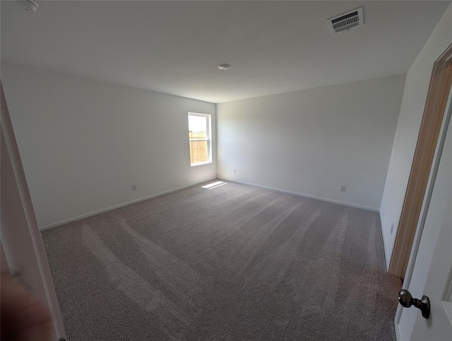 unfurnished room featuring carpet flooring, baseboards, and visible vents